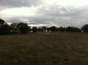 Dark pasture and cloudy skies