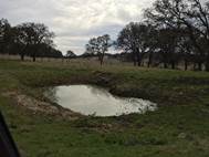 Small pond and cloudy skies