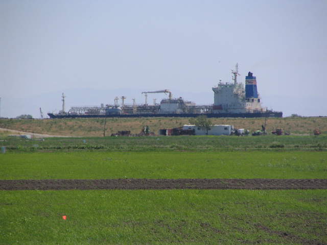 Ship on river above rice paddies