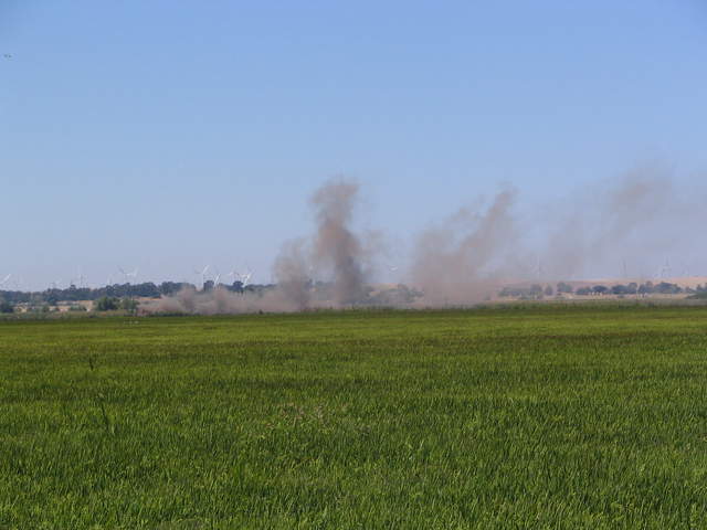 Dust clouds upwind from the rice paddy