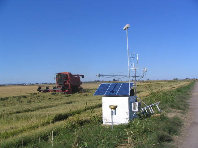 Harvester moving past the rice tower