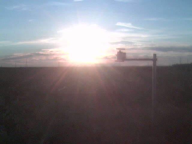 Sun setting into clouds.