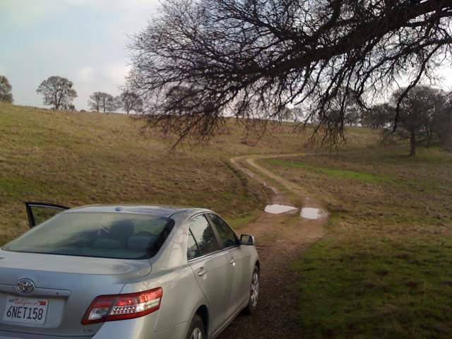 Car entering the Vaira site puddles on road
