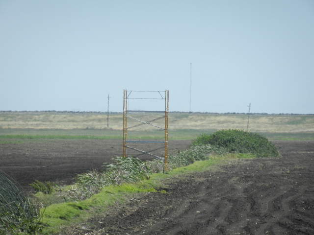 Bare scaffolding between soon to be corn fields