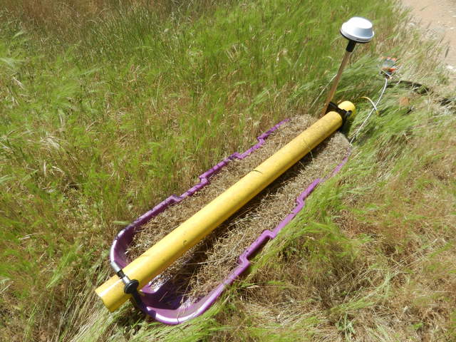 Electro Magnetic Inductance sled full of grass seed.