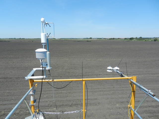 View of the freshly planted corn field with eddy and radiation sensors