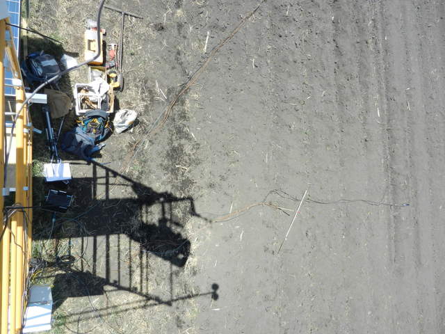 View down from top of scaffolding of row furrows disturbed by sensor installation work