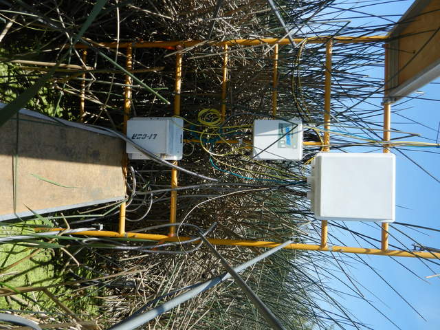 Datalogger enclosure, 7550 box, and 7700 wash reservoir hanging on the scaffolding