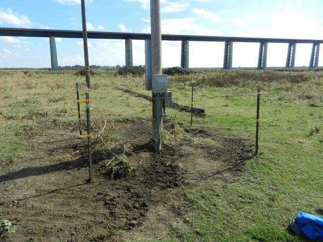 Rebuilt power pole cow fence with electric wire