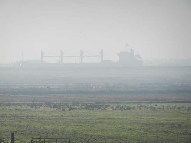 Ship over the rice fields in the fog.