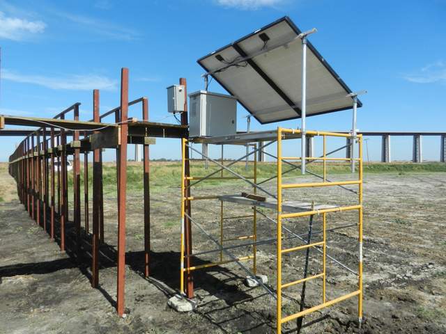 Upgraded solar scaffolding at Sherman wetland, now with concrete blocks under the scaffolding feet