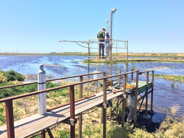 Max, Patty, and Joe building a platform and installing the LGR isotope system