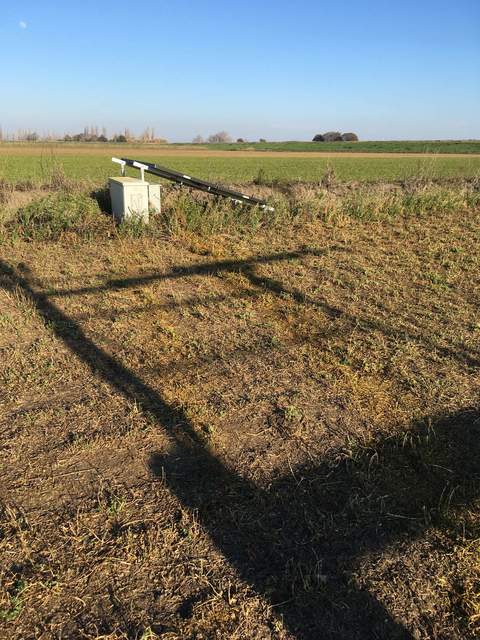 Two strips of yellow paint on the field between the tower and the power box. Joe suspects they