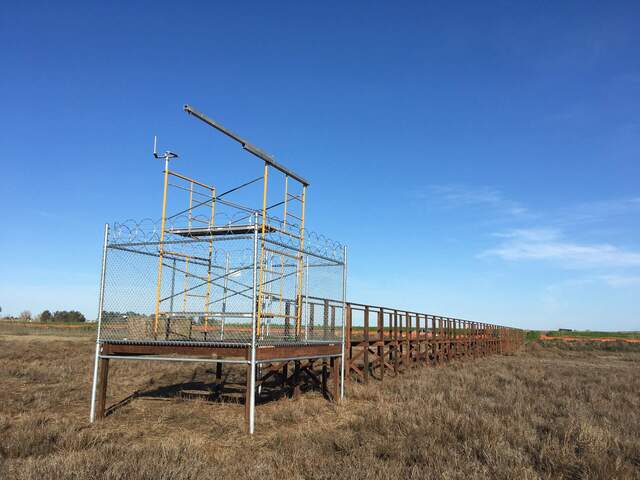 Scaffolding set up on platform inside security fence