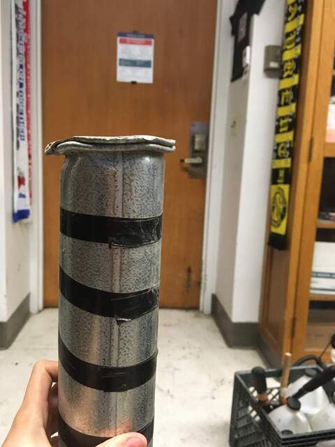 The metallic tube bent and flattened due to hammering