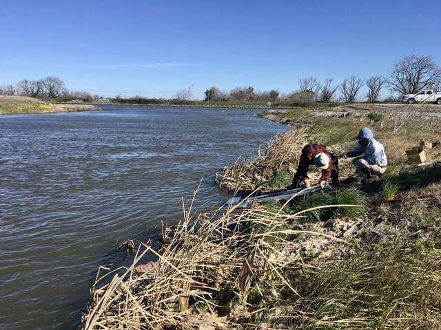 Joe and Daphne installing ADCP track at channel edge