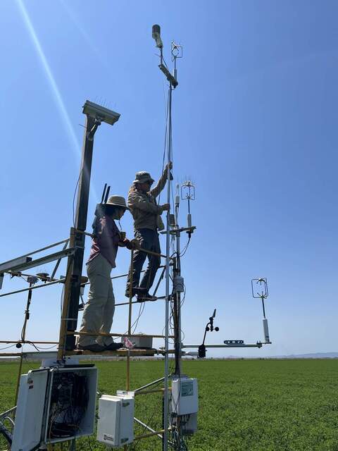 Daphne and Joe on the main tower setting up the extra sonics for the advection experiment
