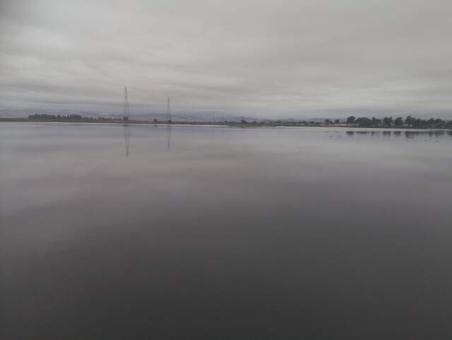 Clouds reflected on still water