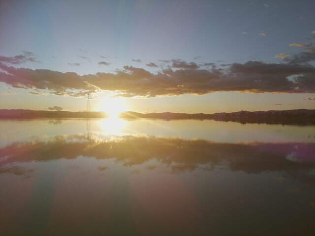 Clouds reflected in water at sunset