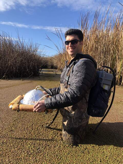Arman carrying a Licor analyzer in my backpack and carrying a homemade dark chamber during Kuno