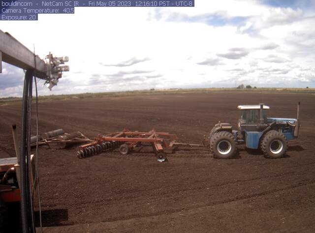 Tractor work on the field, disking, rolling