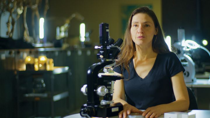 Bree Rosenblum with microscope in front