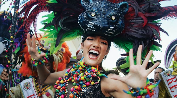 A woman dressed in a colorful carnaval costume of a black panther