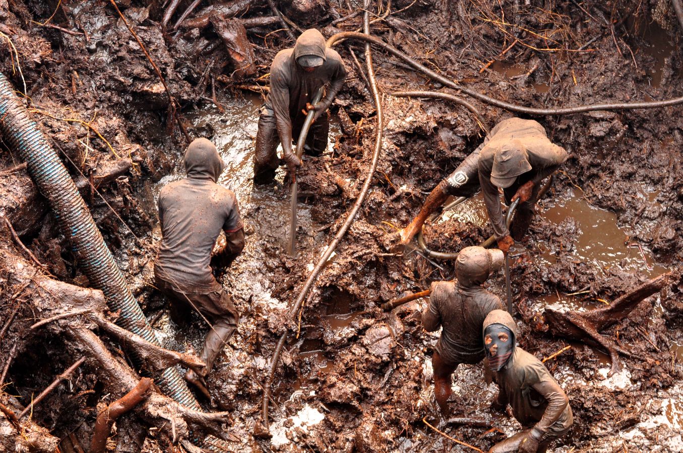 Miners in a gold mine pit in Indonesia